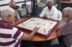 Friends enjoying a game of Carrom Board at NMT's Day Care Centre, Hyderabad